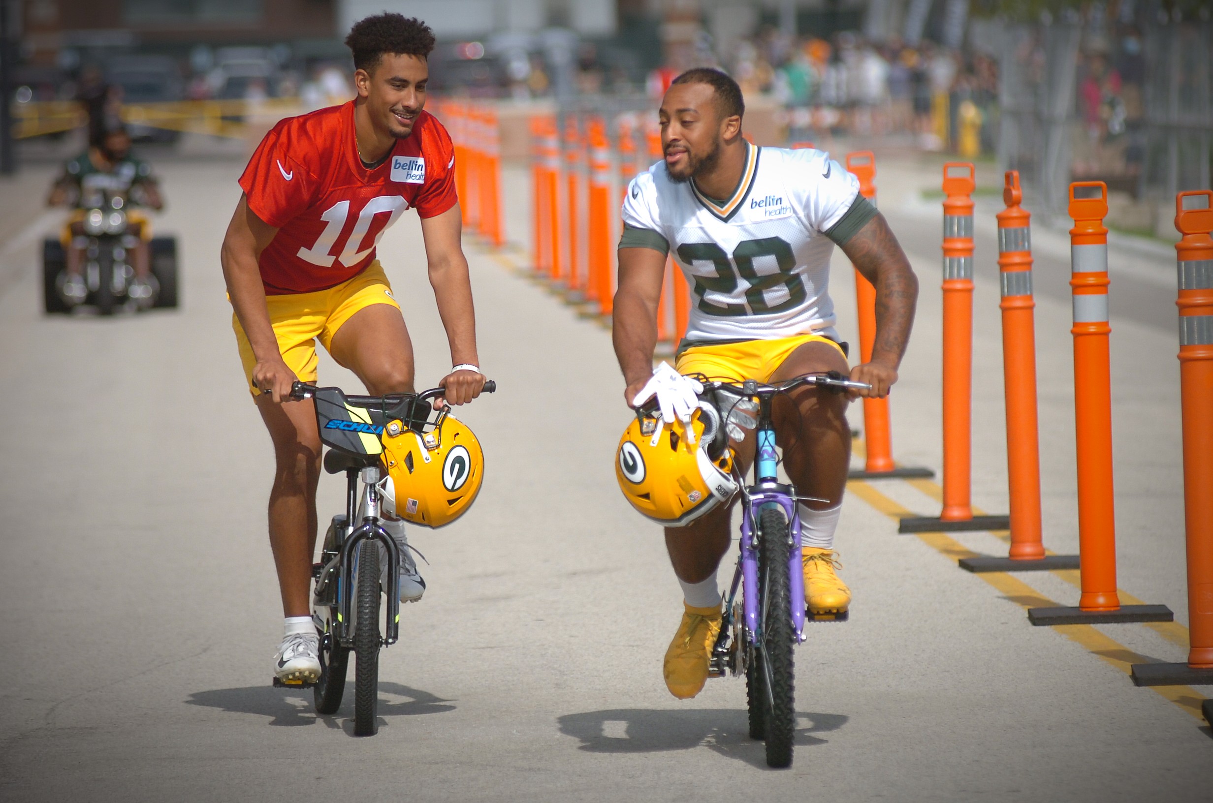 Jordan Love and A.J. Dillon ride bikes to practice Monday. Ashwaubenon Community News photo by Dan Plutchak